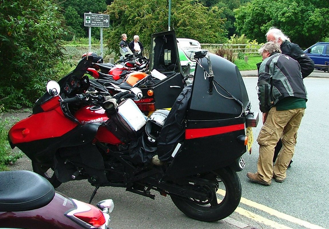 Camera mounted to left side of motorbike topbox you can operate by rewiring the headlamp flasher to take a still picture